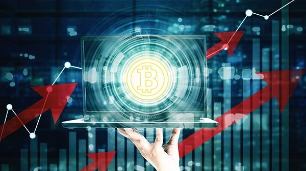 Man hand showing bitcoin button on monitor laptop